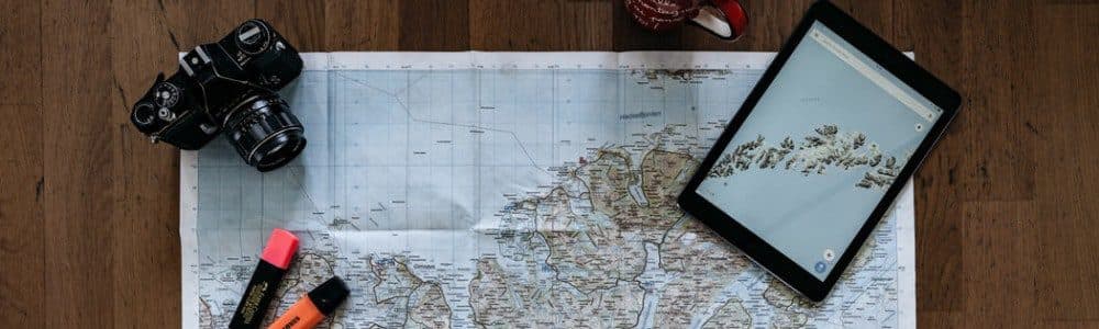 person looking at map on brown parquet floor